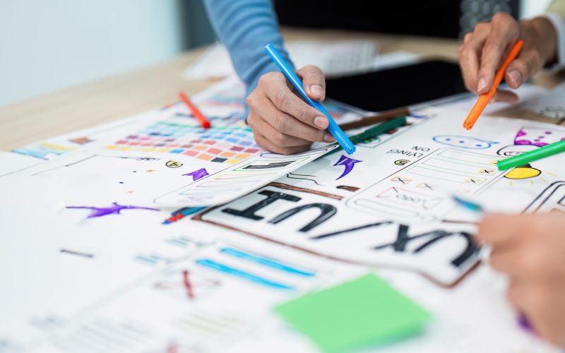 team of UI UX web designer are working together to develop mobile responsive websites with UI UX front end designer previews.