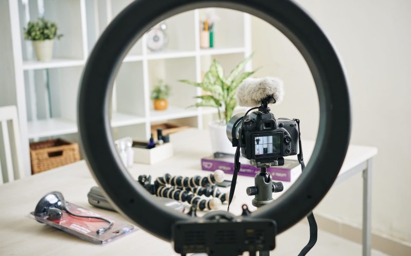 Circle lamp, digital camera and monopods in office of professional blogger